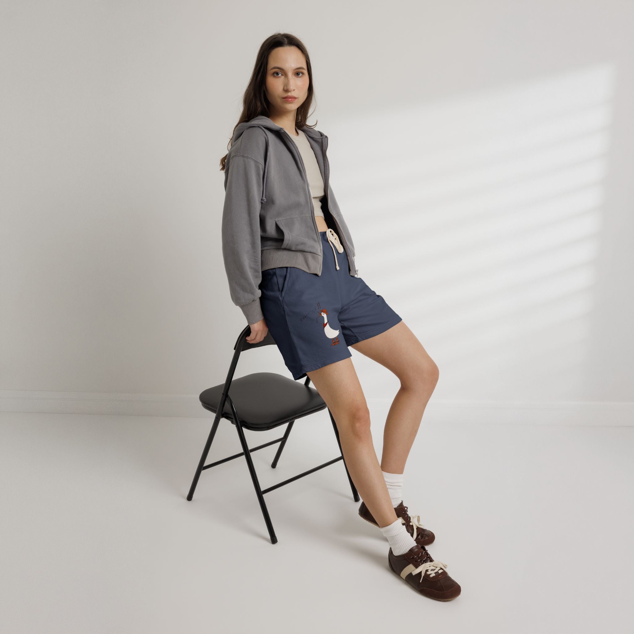 Navy drawstring sweat shorts with cartoon duck graphic on left leg
