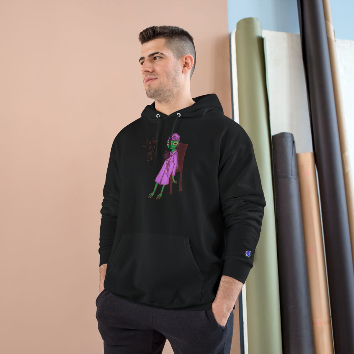 Black unisex hoodie with hood, kangaroo pocket, long sleeves, and colorful front graphic