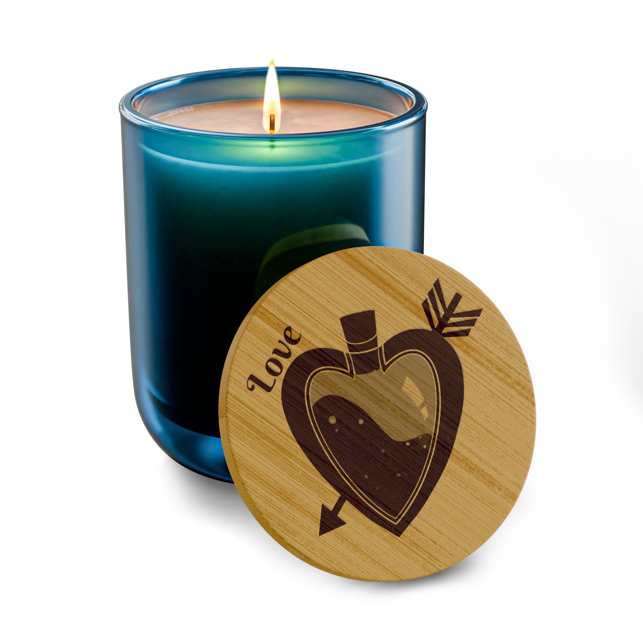 Deep blue soy candle with lit wick and round engraved wooden lid with heart design.