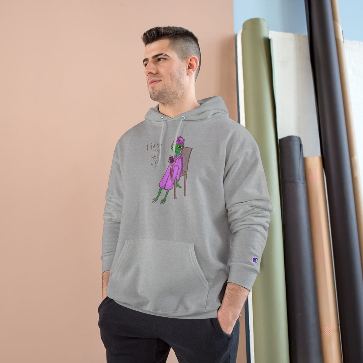 Unisex charcoal heather hoodie worn by model, with character graphic on the chest