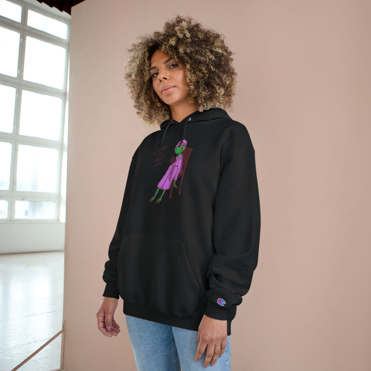 Black unisex hoodie with hood, kangaroo pocket, long sleeves, and colorful front graphic