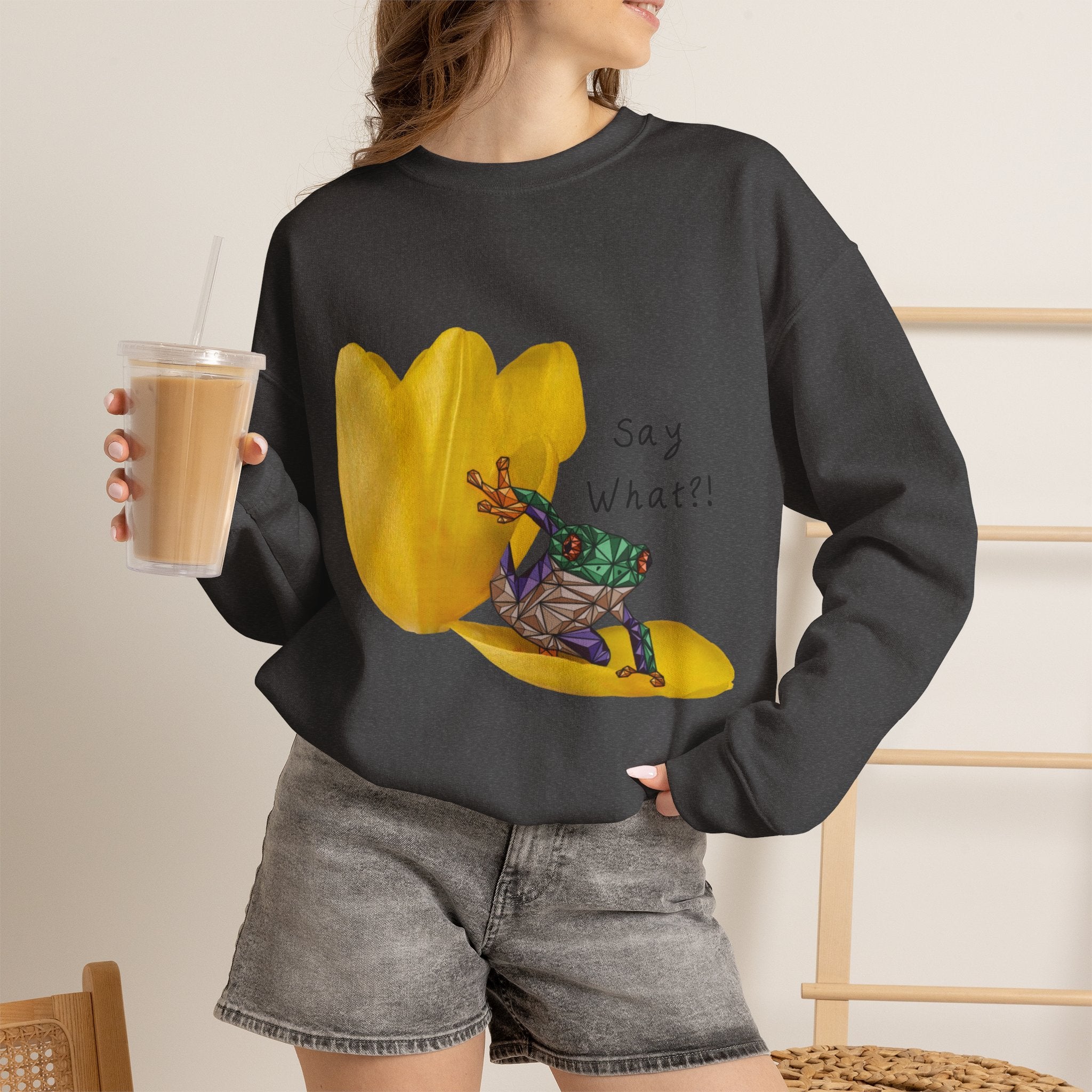 Black crewneck sweatshirt on model with yellow tulip frog graphic and “Say What?!”