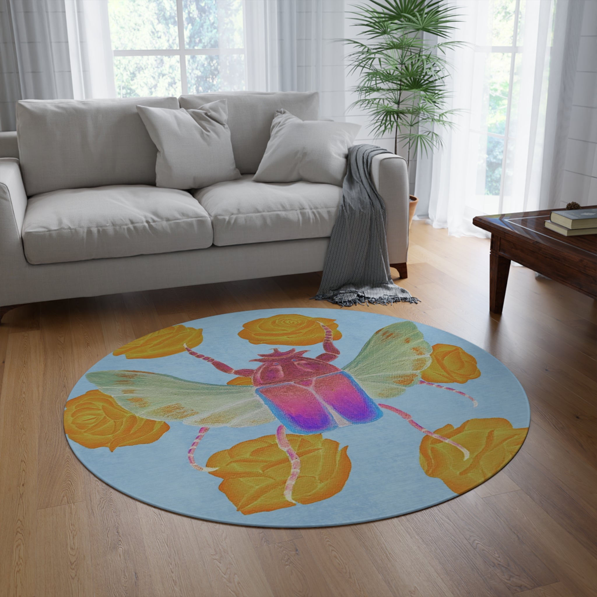 Round area rug with blue field, colorful beetle and yellow rose accents