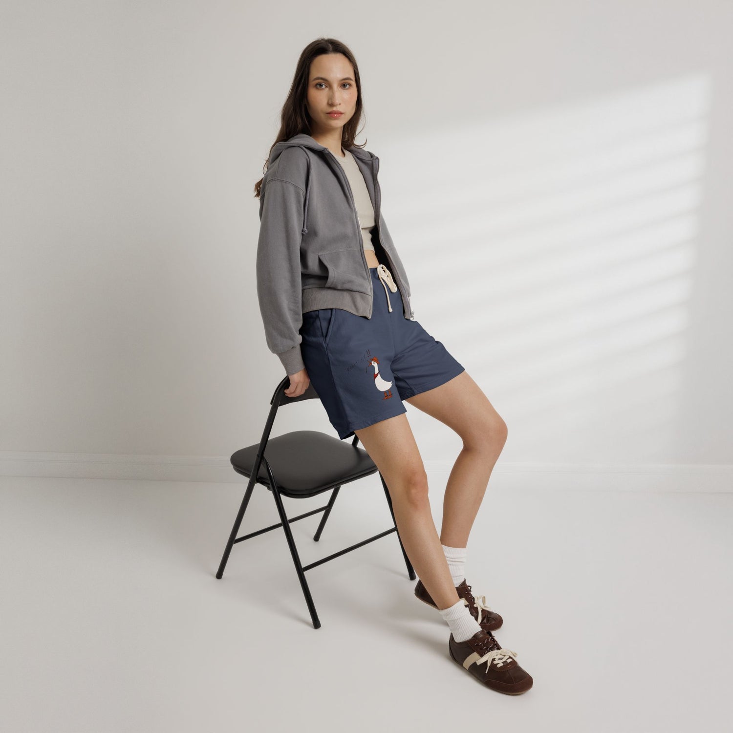 Navy drawstring sweat shorts with cartoon duck graphic on left leg