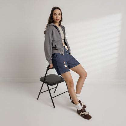 Navy drawstring sweat shorts with cartoon duck graphic on left leg