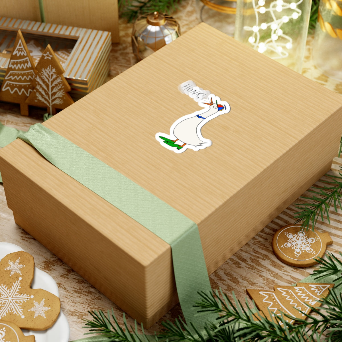 Cartoon goose “HONK!” kiss-cut sticker on a wrapped gift box with green ribbon