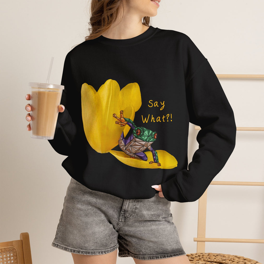 Black crewneck sweatshirt with yellow tulip frog graphic and “Say What?!” text