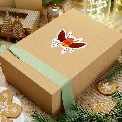 Beetle kiss-cut sticker on wrapped gift box, orange-and-red beetle with white outline