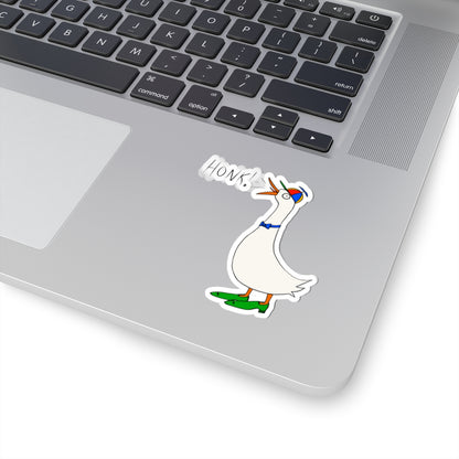 Cartoon goose “HONK!” kiss-cut sticker on a laptop keyboard and trackpad area