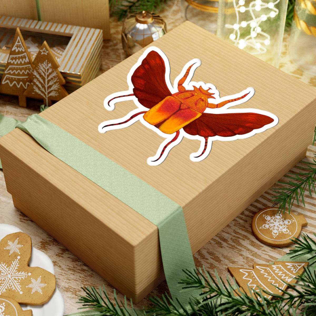 Beetle kiss-cut sticker on gift box lid, red-winged orange beetle with white outline