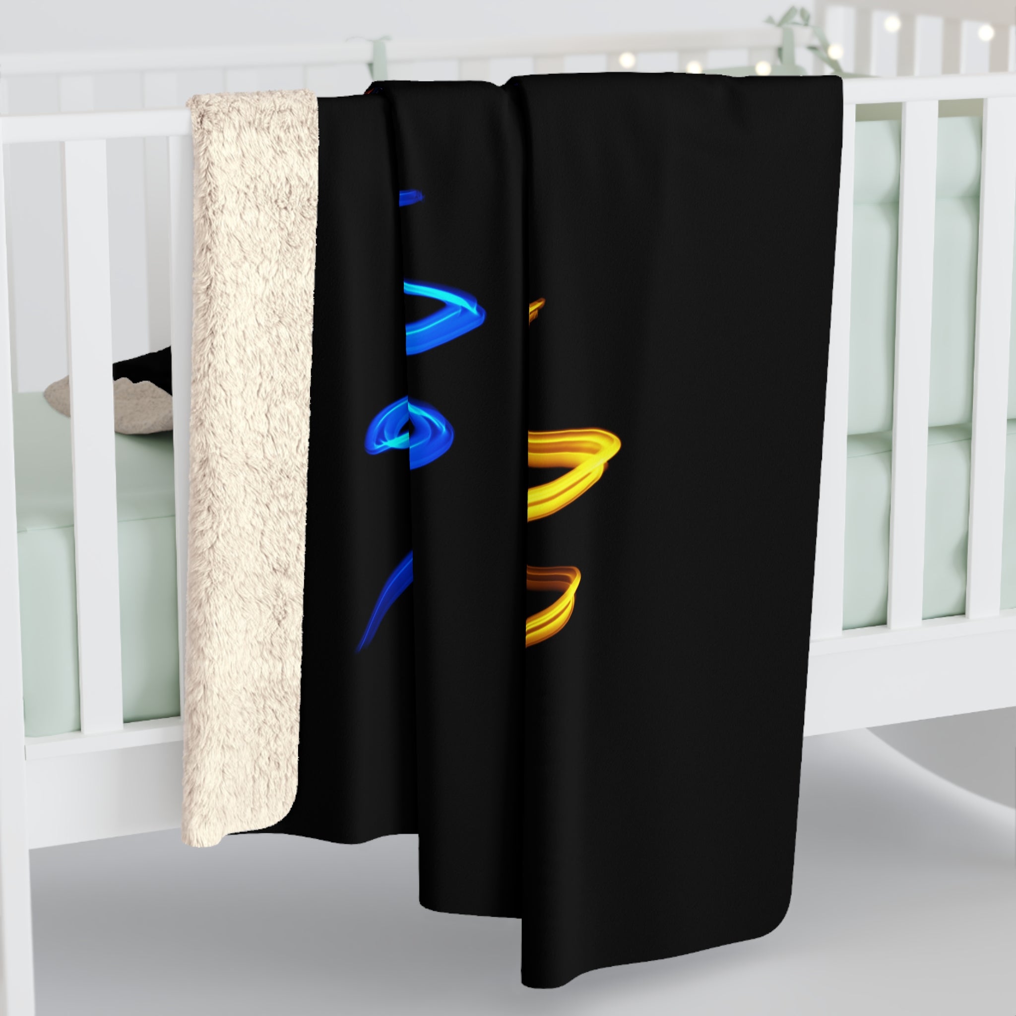 Sherpa fleece blanket draped over railing, off-white plush edge and black parrot spirals