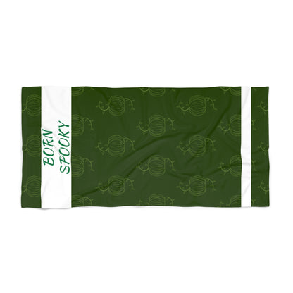 Green pumpkin-themed beach towel with repeating pumpkin pattern and white side stripes