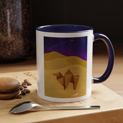 White coffee mug with navy rim and handle, desert-night camel graphic in the center