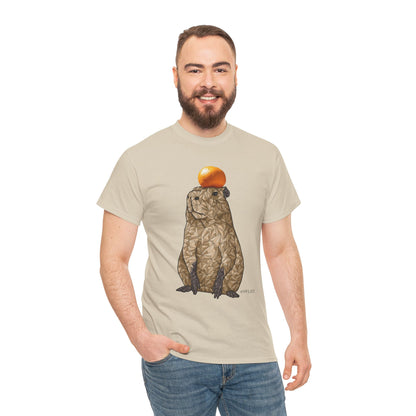 Unisex heavy cotton T-shirt in natural beige, capybara with orange fruit graphic