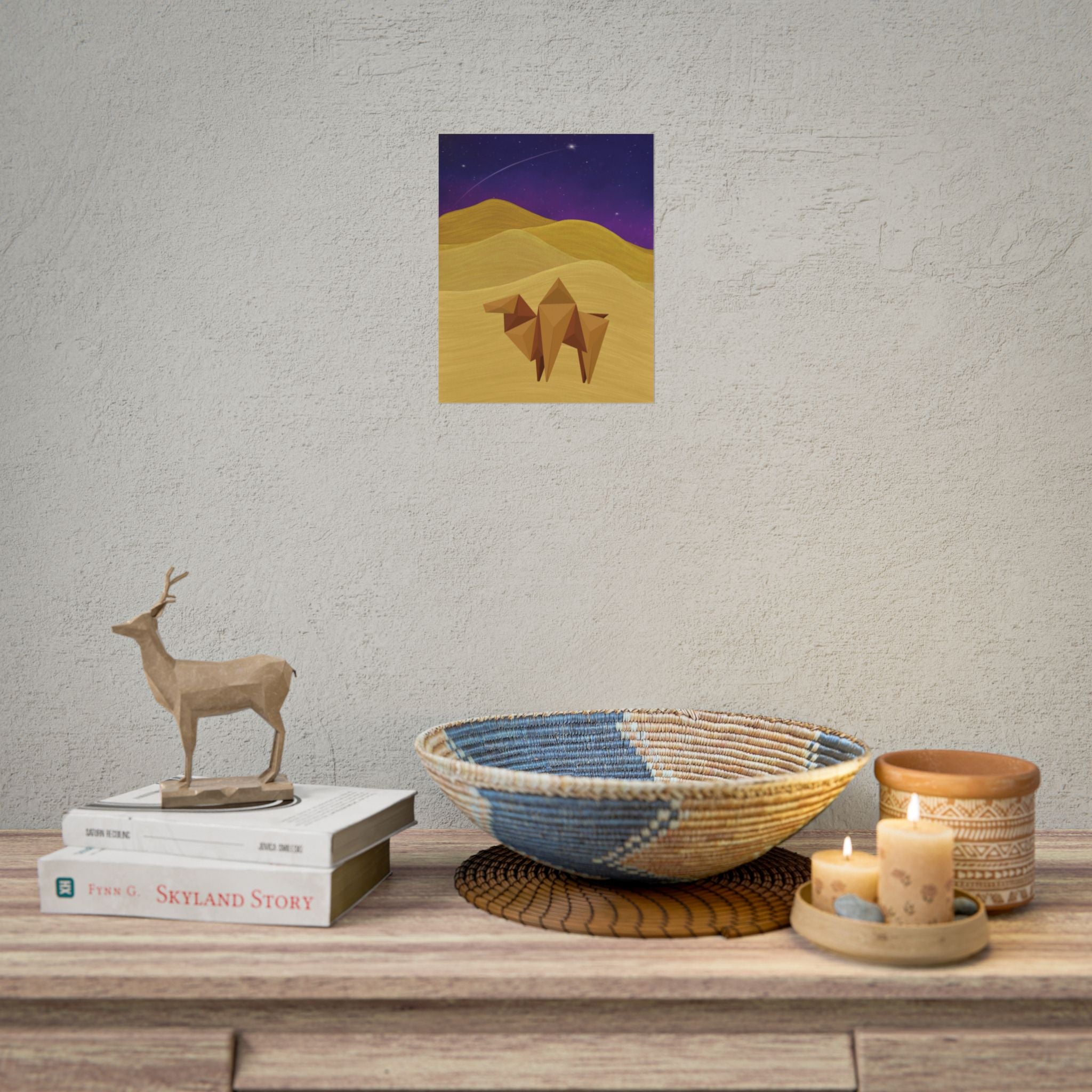 Square desert camel art print on wall, showing geometric camel in gold dunes and stars
