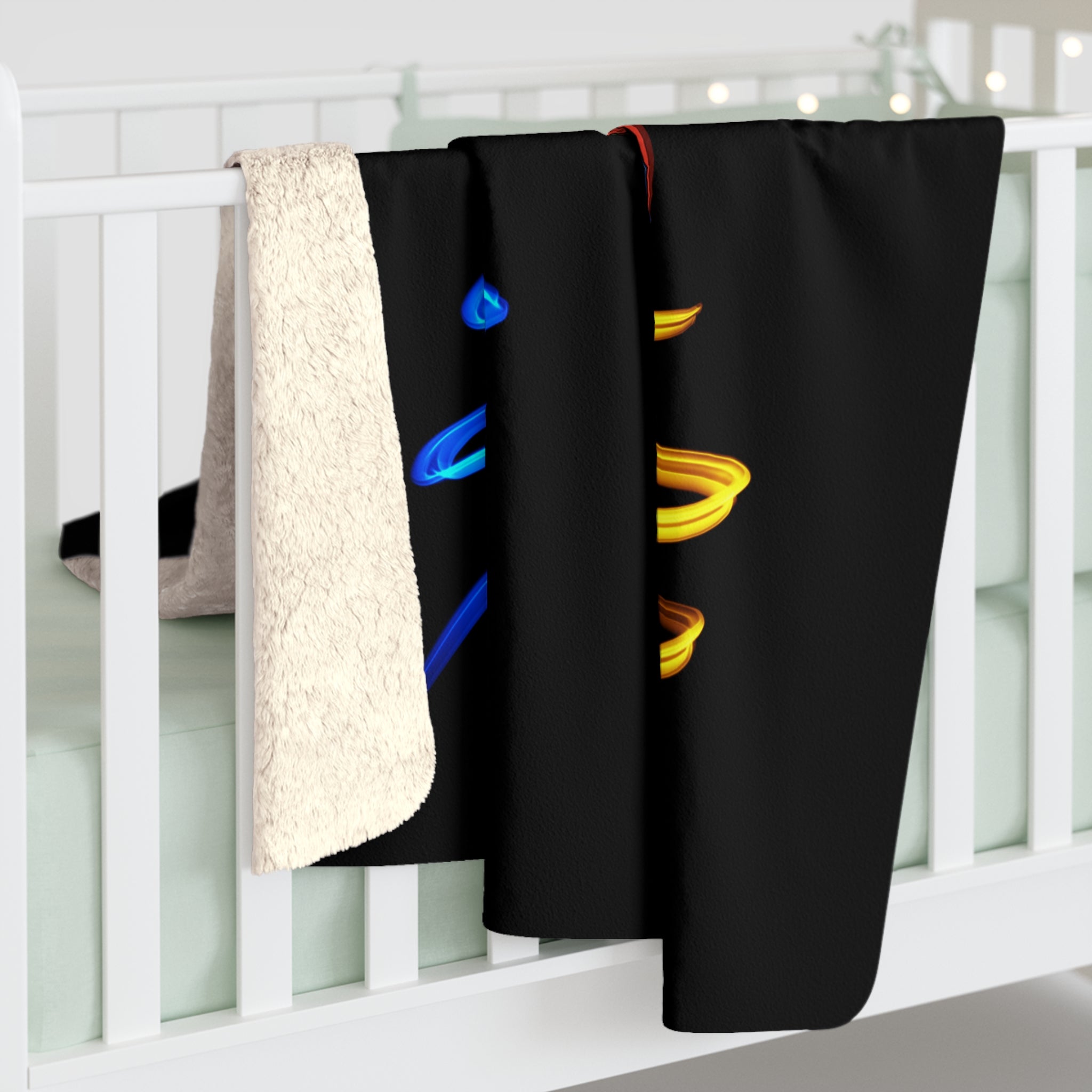 Sherpa fleece blanket over railing with off-white fuzzy back and black parrot spirals