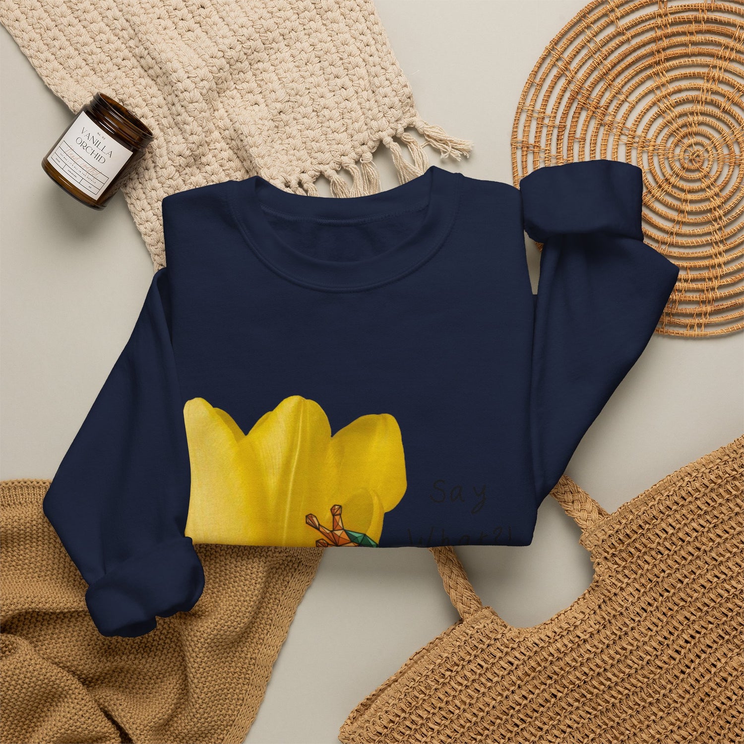 Navy crewneck sweatshirt laid flat with yellow tulip frog graphic