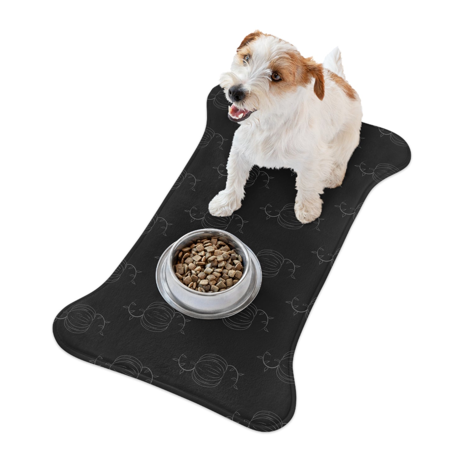 Black pet feeding mat with pumpkin pattern, dog with bowl of kibble on it