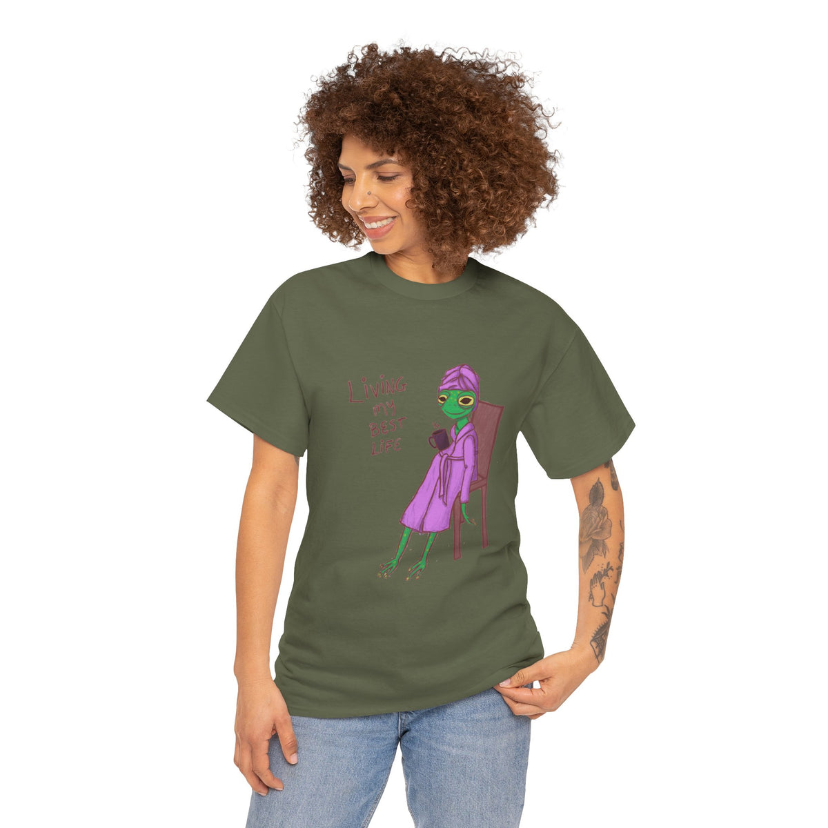 Dark green short-sleeve graphic t-shirt worn by woman, purple character design
