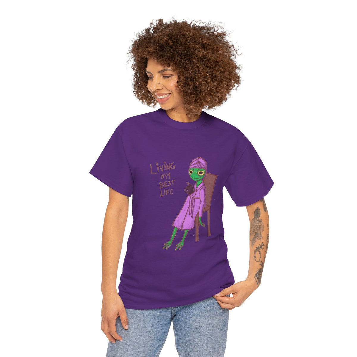 Purple graphic T-shirt worn by woman, “Living my Best Life” character print