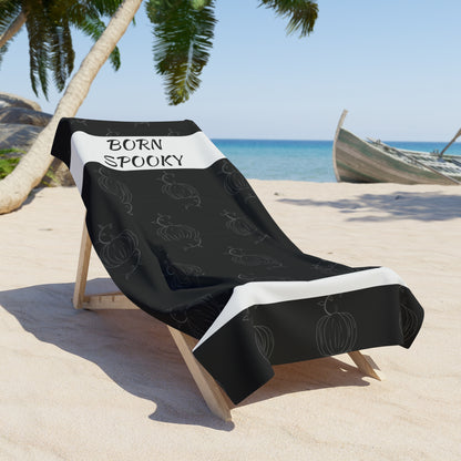 Black towel with white edges draped on chair, &