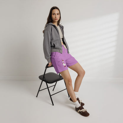 Purple drawstring sweat shorts with cartoon duck graphic on left leg
