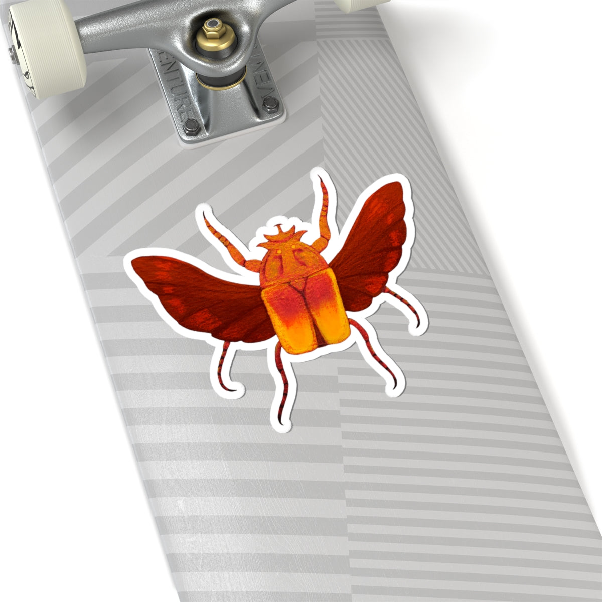 Beetle kiss-cut sticker on striped gray luggage: orange beetle with red wings and white outline