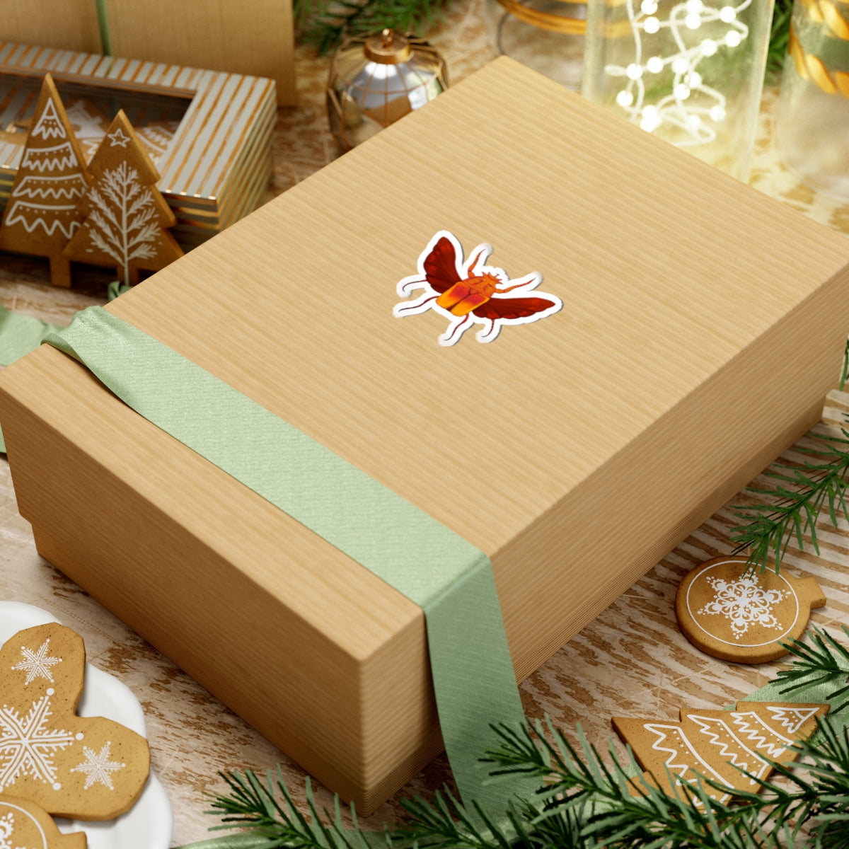 Red and orange beetle kiss-cut sticker on a wrapped gift box