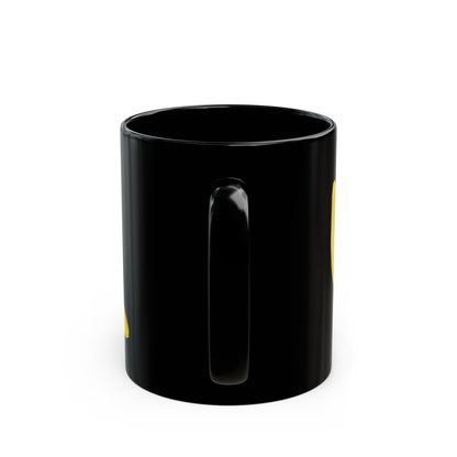 Black ceramic mug with partial yellow tulip and frog graphic on the side
