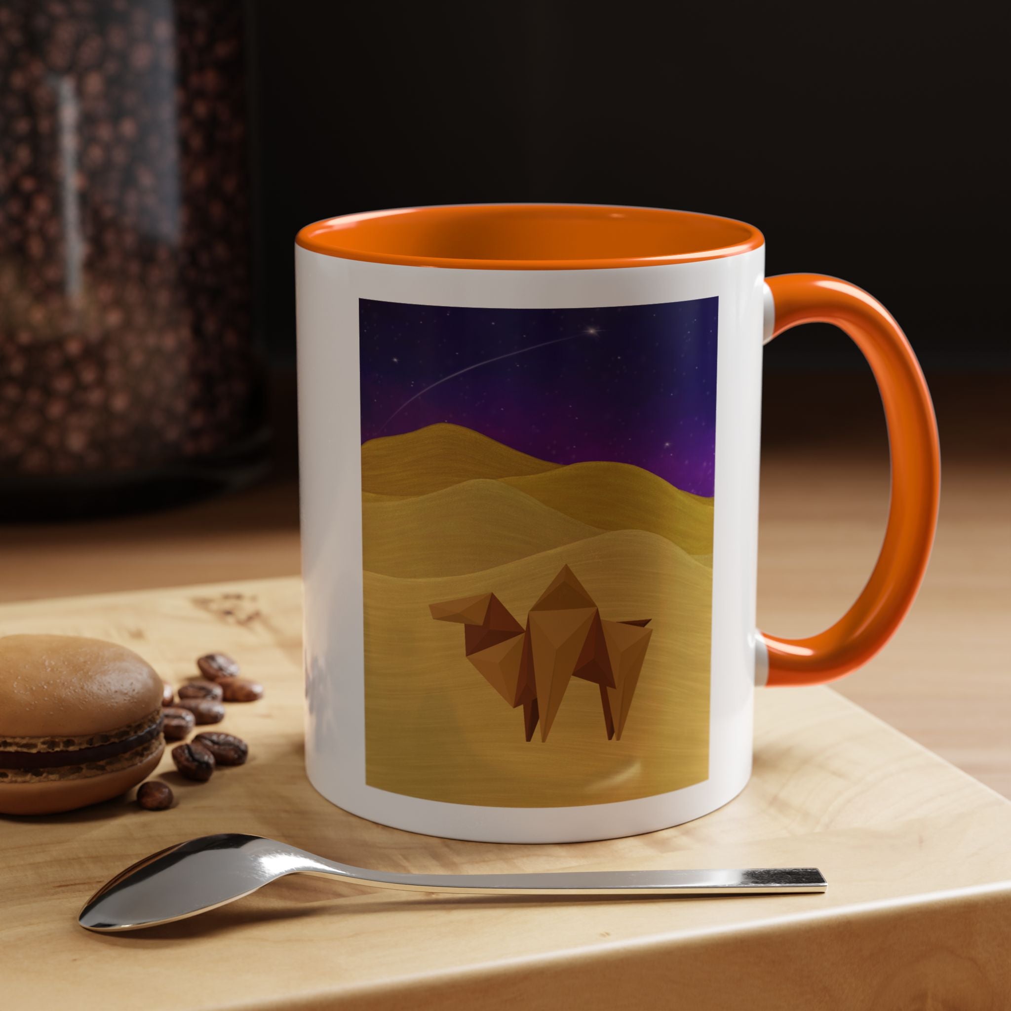 Coffee mug with orange handle and rim, white body, origami camel desert night sky print