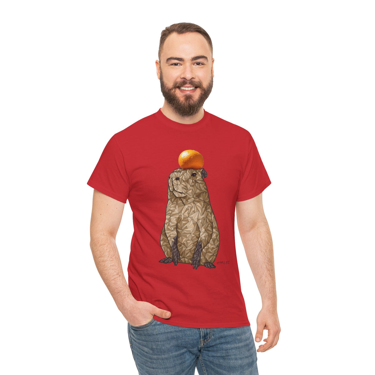 Red unisex T-shirt on model with capybara graphic holding an orange