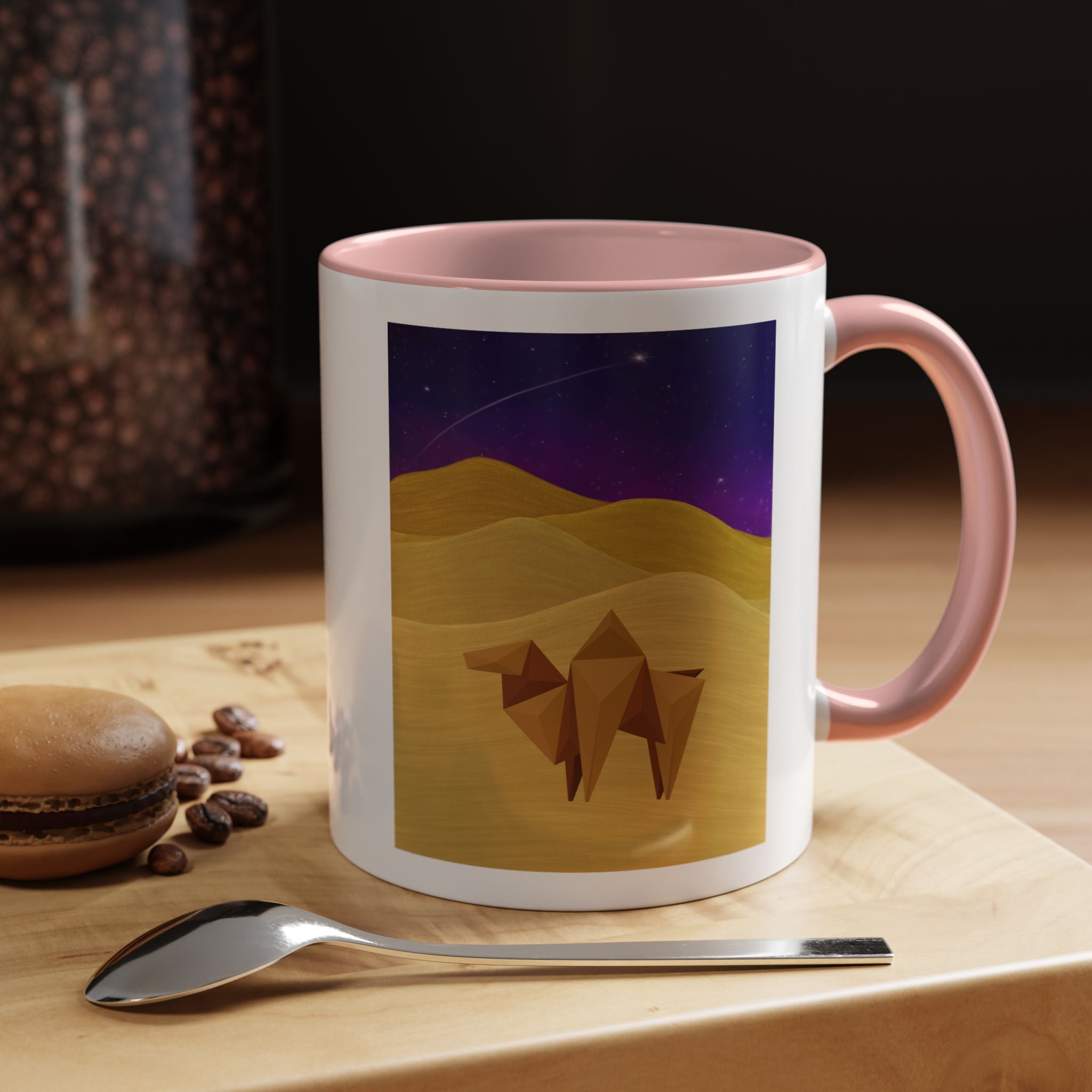 White coffee mug with pink rim and handle, desert-night camel graphic on the front