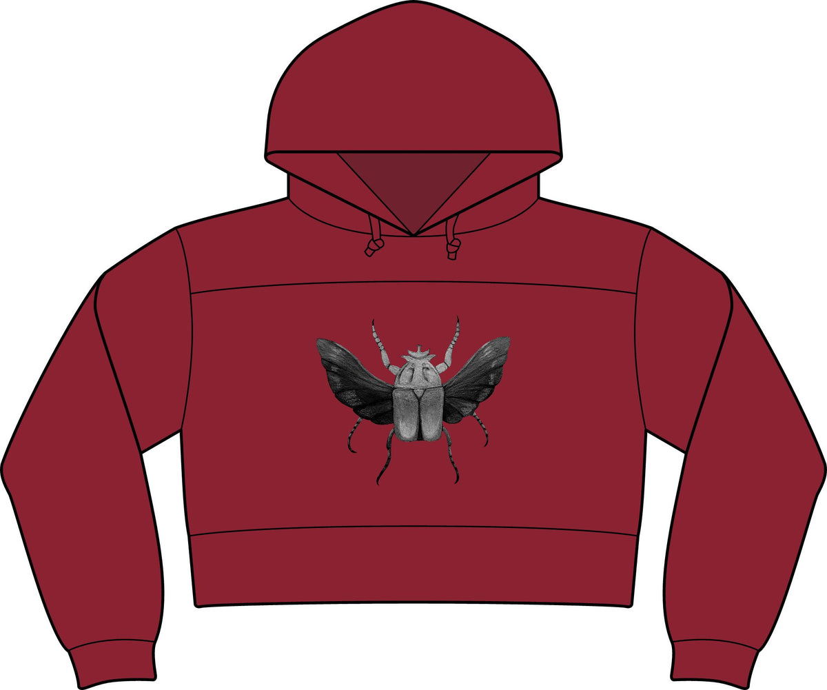 Cropped fleece hooded sweatshirt in brick red, featuring insect graphic and front pocket.