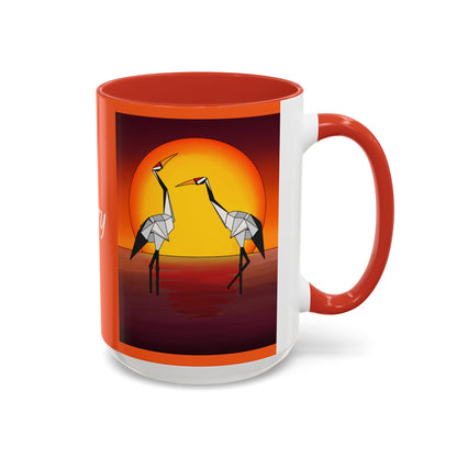 Red coffee mug with origami crane sunset print, red handle and rim, front view.