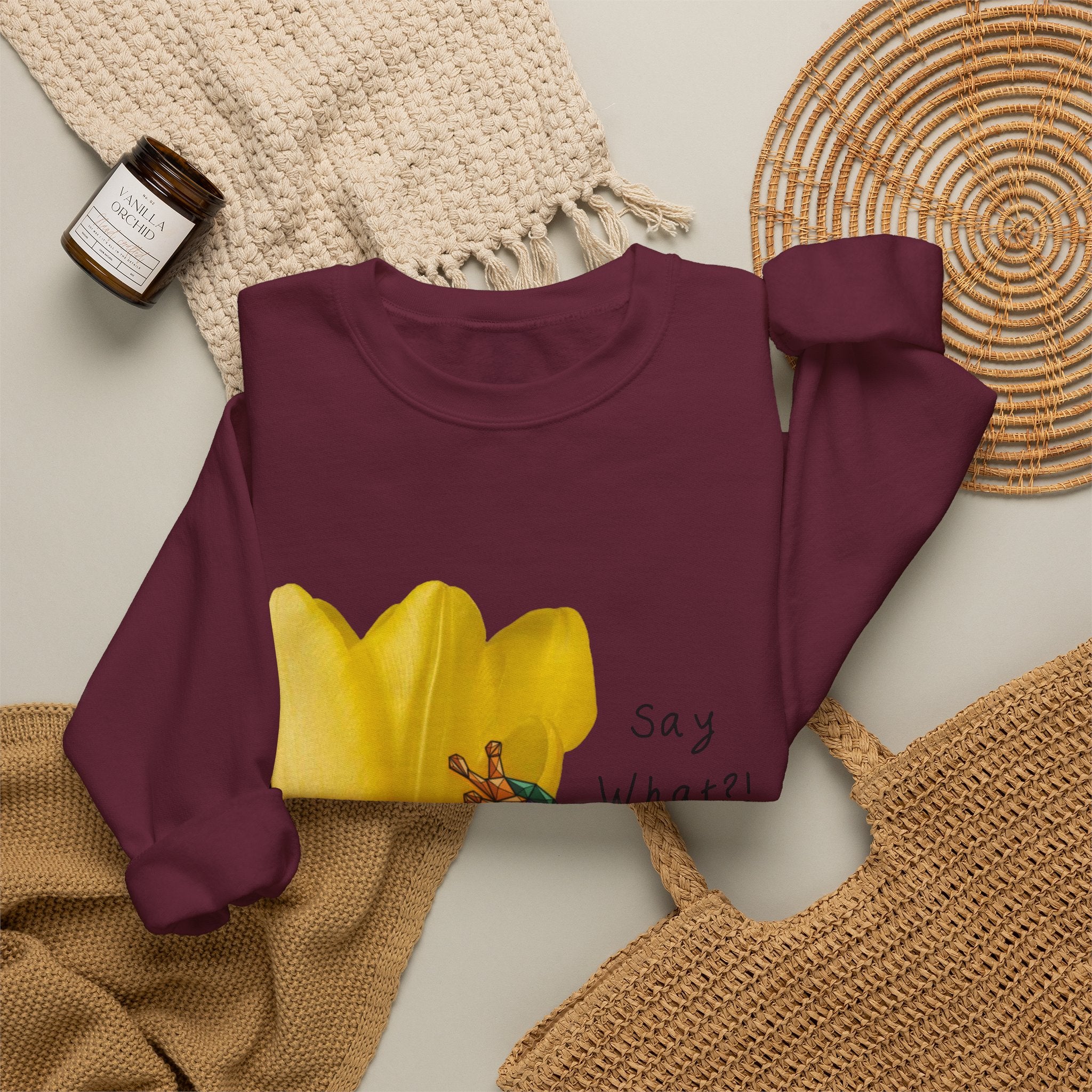 Maroon crewneck sweatshirt laid flat with yellow tulip frog graphic and “Say What?!” text