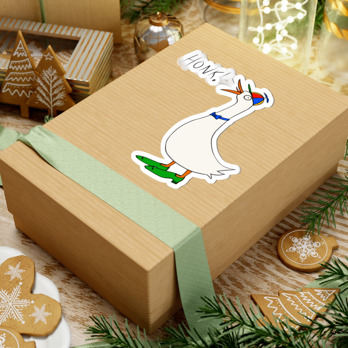 Cartoon goose “HONK!” kiss-cut sticker on a wrapped gift box with green ribbon