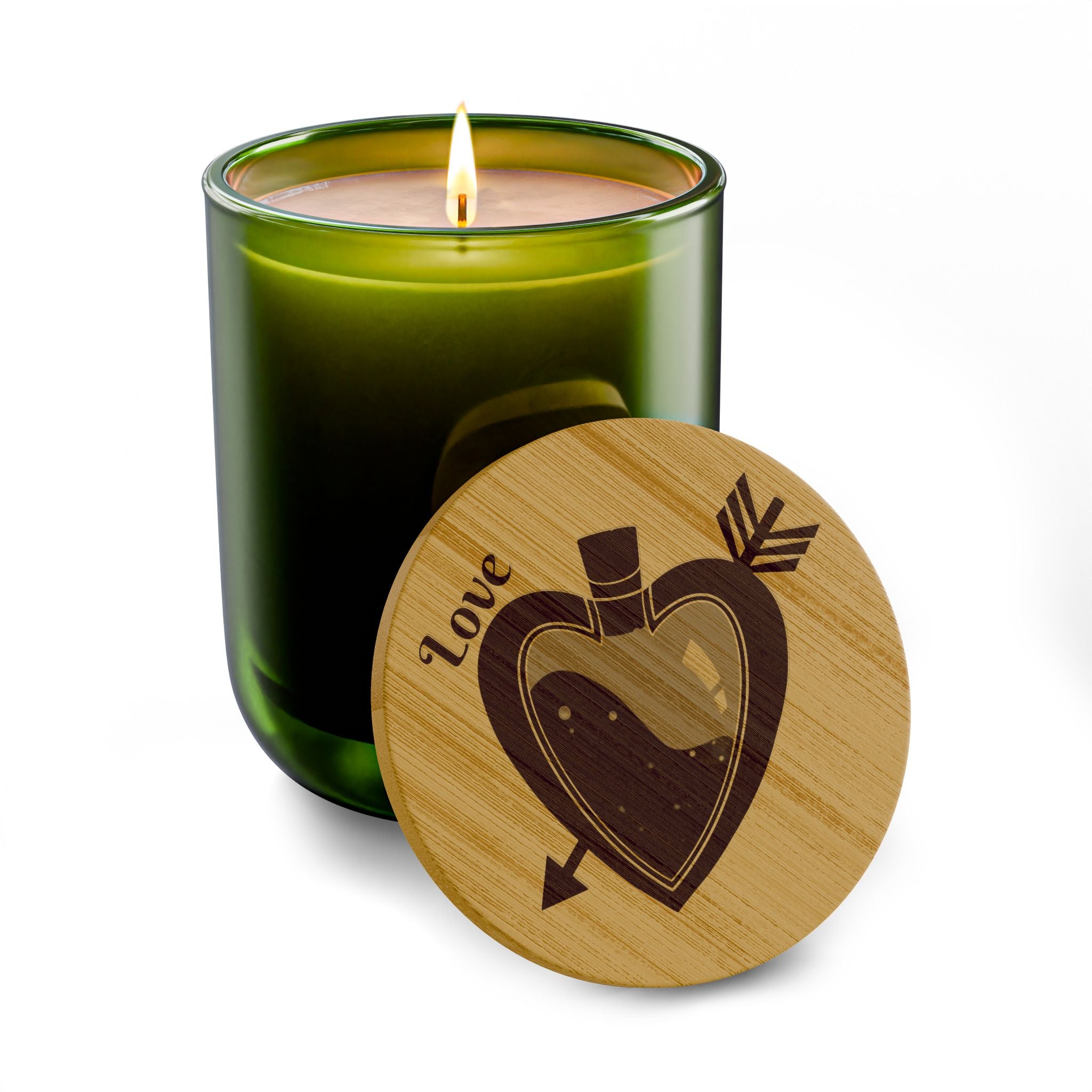 Olive green soy candle with lit wick and round engraved wooden lid with heart design.