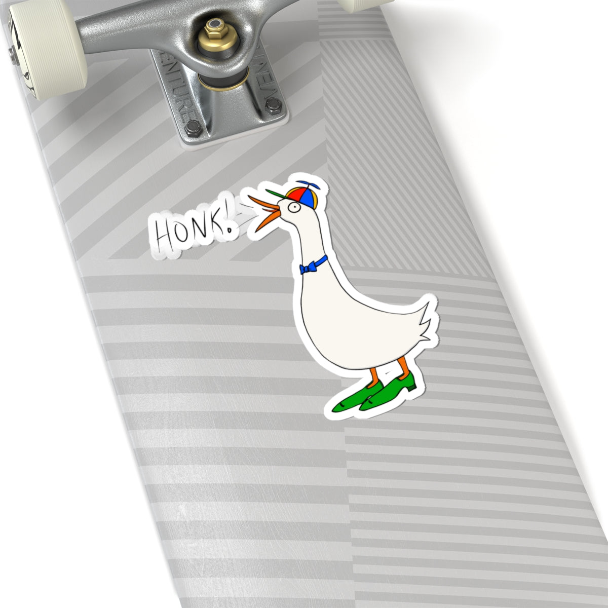Cartoon goose “HONK!” kiss-cut sticker on a striped mouse pad near keyboard