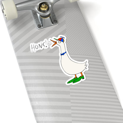 Cartoon goose “HONK!” kiss-cut sticker on a striped mouse pad near keyboard