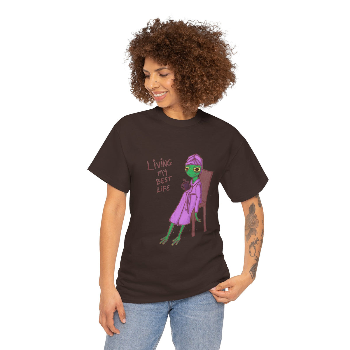 Dark brown graphic t-shirt on model with “Living my Best Life” character print
