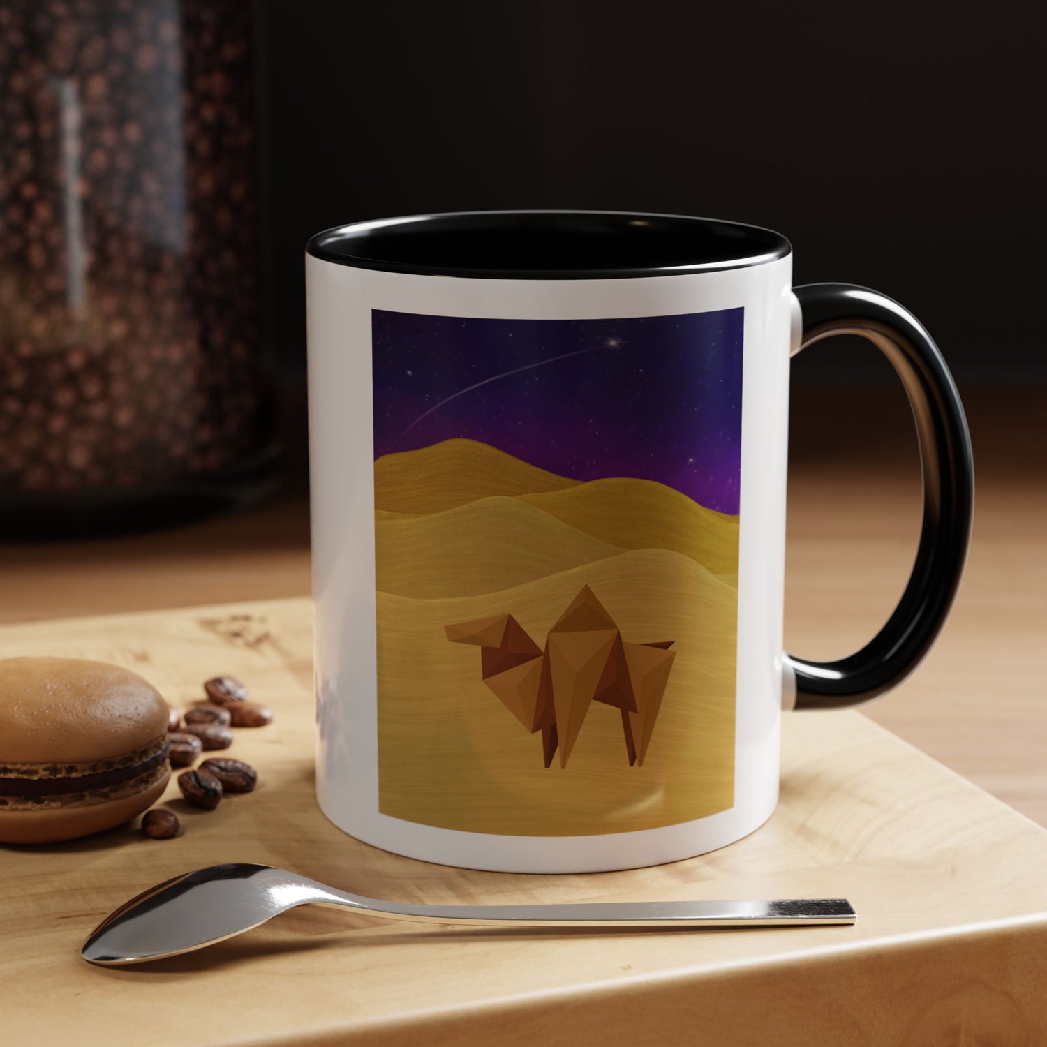 White coffee mug with black handle and rim; origami camel desert night sky graphic