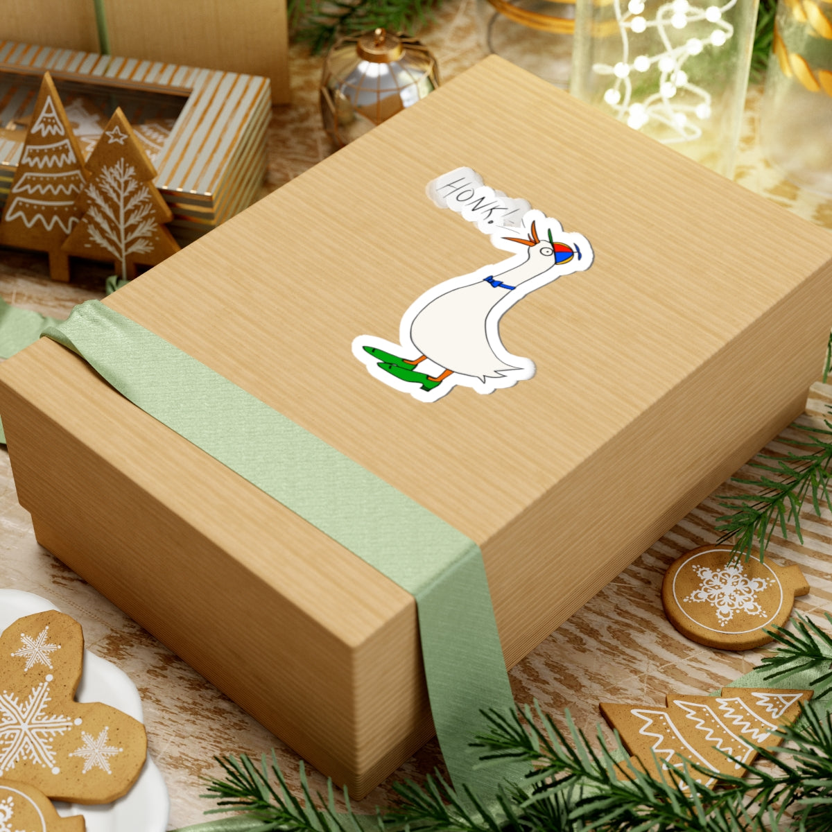Cartoon goose “HONK!” kiss-cut sticker on a wrapped present with green ribbon