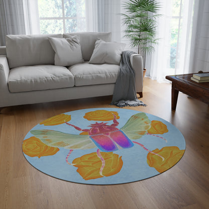 Round area rug with blue field, colorful beetle and yellow rose accents