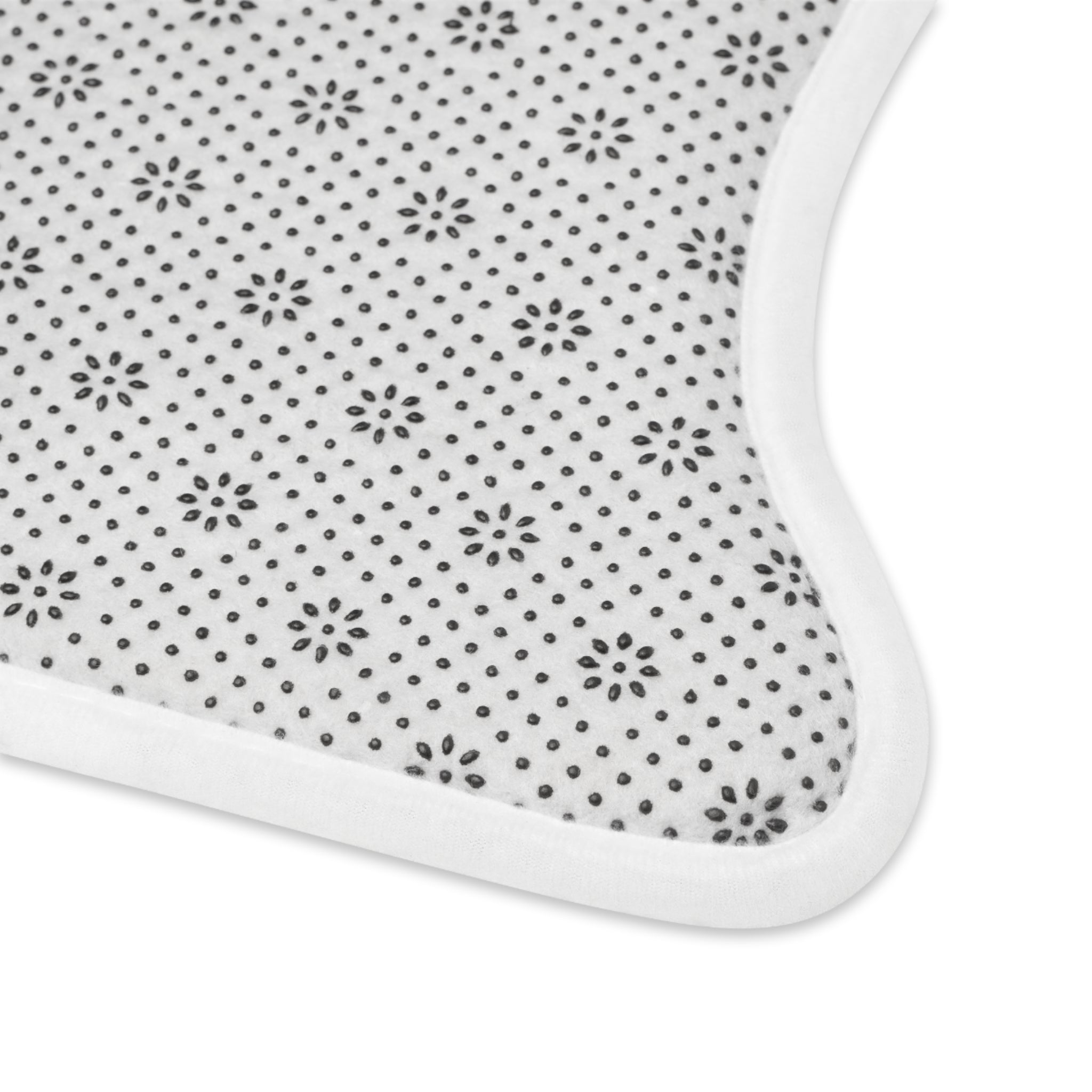 White pet feeding mat with small dark starburst dots and rounded corner edge