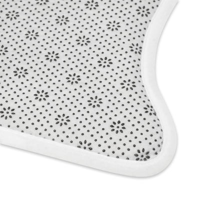White pet feeding mat with small dark starburst dots and rounded corner edge