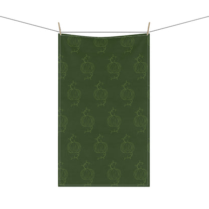 Hanging green tea towel with repeating pumpkin line pattern and clothespins