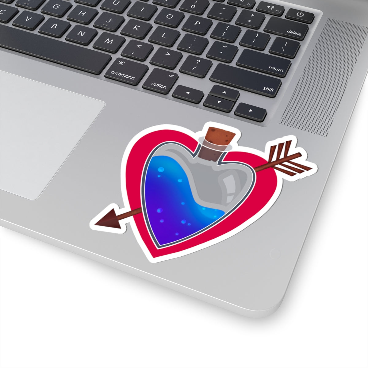 Heart potion kiss-cut vinyl sticker on a laptop keyboard, blue liquid flask and red border