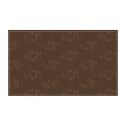 Brown tea towel with repeating pumpkin line pattern, long horizontal rectangle