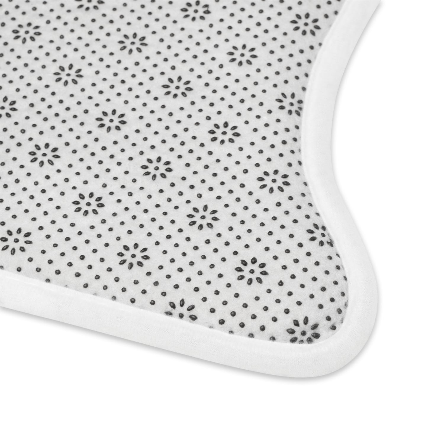 Pet feeding mat corner with white border and small dark dot pattern fabric