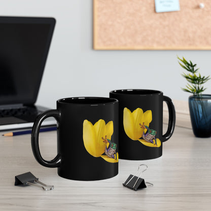 Two black ceramic mugs with yellow tulip and frog graphic on the sides